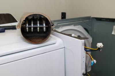 dryer sheet being placed into laundry machine