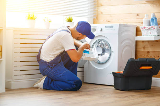 An experienced appliance technician from ACR fixing a washer in 