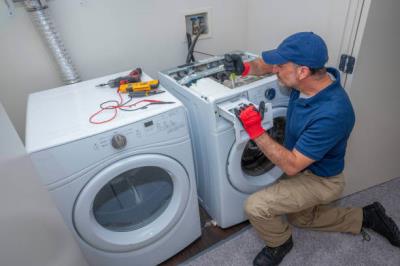 dryer sheet being placed into laundry machine