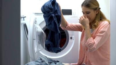 dryer sheet being placed into laundry machine