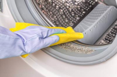 dryer sheet being placed into laundry machine