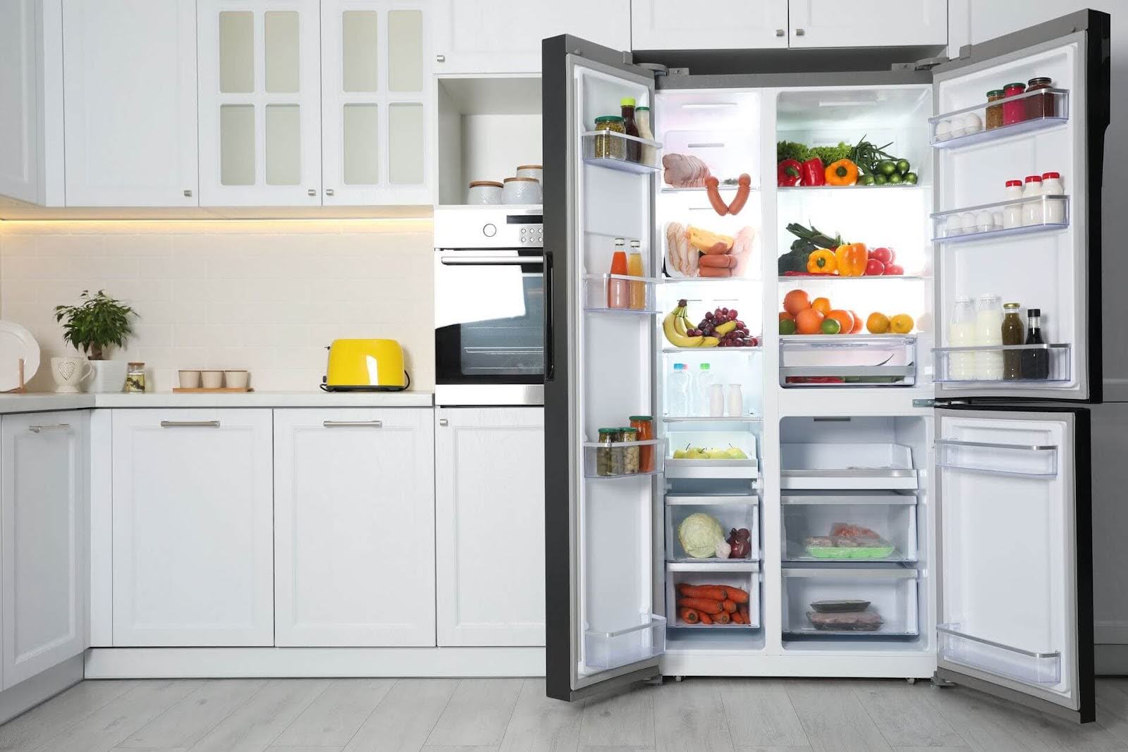 A side-by-side refrigerator wide open and full of food - ACR is your local source for Bosch refrigerator repairs. Contact us today!