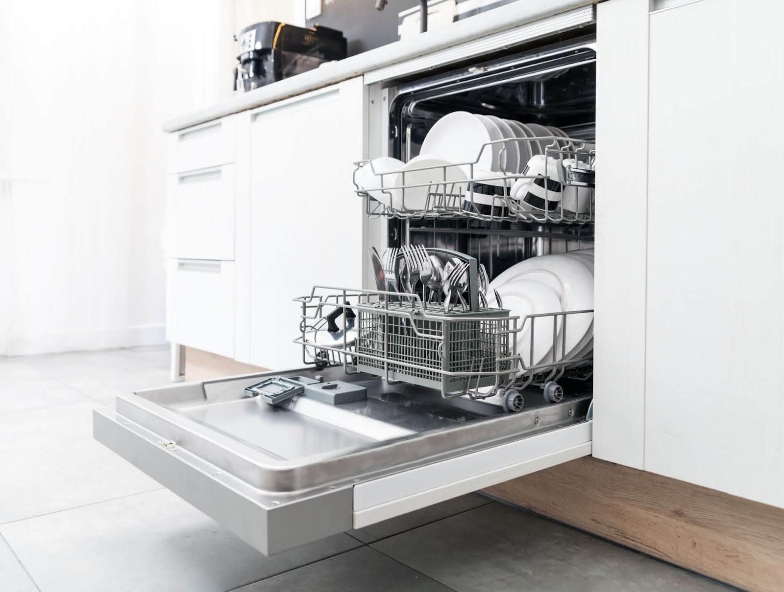 An open dishwasher full of dishes - ACR repairs Bosch dishwashers. Call (480) 466-9606 now!